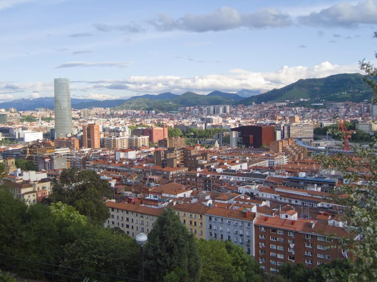 The residential district of Deusto in Bilbao seen from the hillside above, the river beyond.