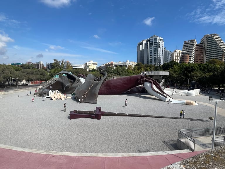 The giant reclining Gulliver figure in Valencia's Turia gardens, its slides and ramps covered with children at play.